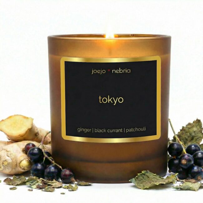 Tokyo scented candle by JoeJo + Nebria in amber glass jar with ginger, black currant, and patchouli