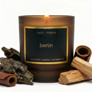 Berlin scented candle by JoeJo + Nebria in amber glass jar with oud wood, leather, and sandalwood
