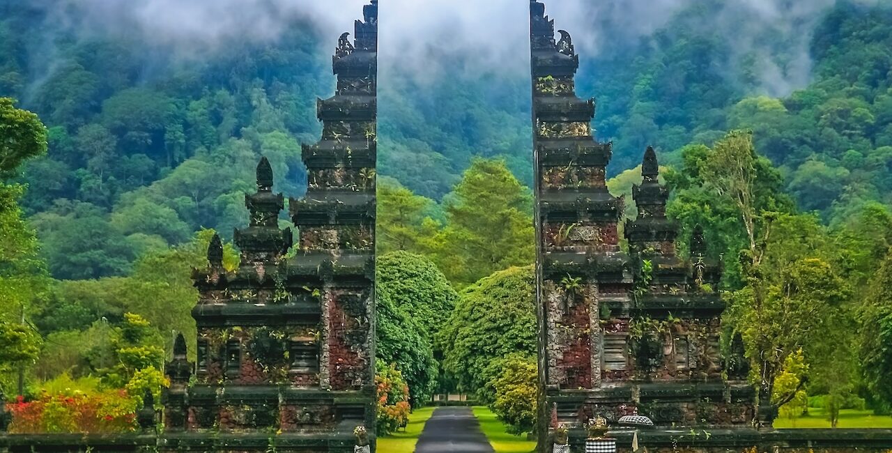 Bali split temple gate with lush jungle and misty mountains in background