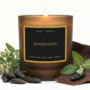 Amsterdam scented candle by JoeJo + Nebria in amber glass jar with tonka bean, clary sage, and leather notes