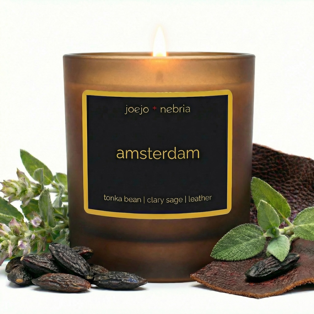 Amsterdam scented candle by JoeJo + Nebria in amber glass jar with tonka bean, clary sage, and leather notes