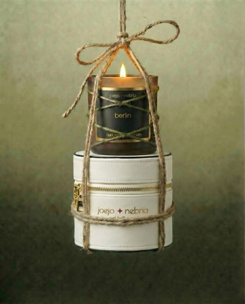Berlin scented candle by JoeJo + Nebria with cream vegan leather container and lit flame