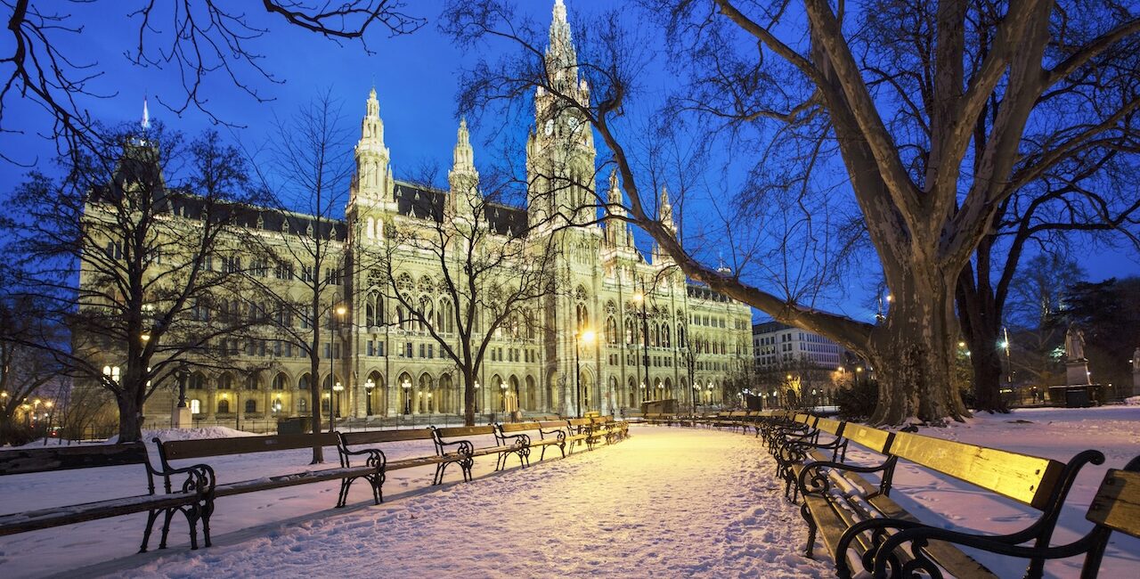 Vienna City Hall illuminated in winter at dusk in Vienna Austria inspiring the Vienna luxury fragrance collection by JoeJo + Nebria